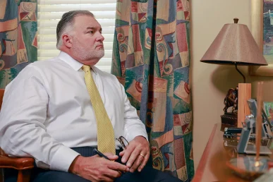 Attorneys joel hamner and tom mccutcheon consult with a client about a distracted driving accident claim.