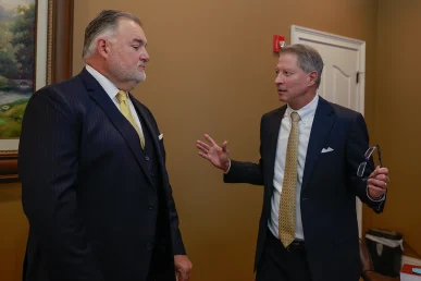 Attorneys tom mccutcheon and joel hamner examine phone records tied to a texting while driving collision.