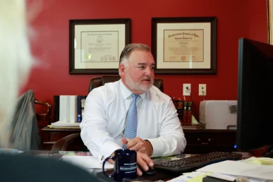 Lawyer joel hamner discusses a distracted driving accident exhibit with a client, including phone record evidence.