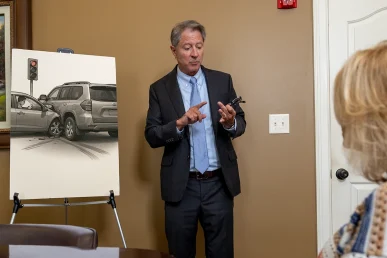 Personal injury attorney tom mccutcheon consults with a client about a distracted driving accident claim.